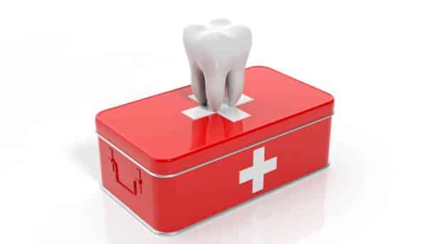 3D rendering of tooth and first aid kit, isolated on white background.